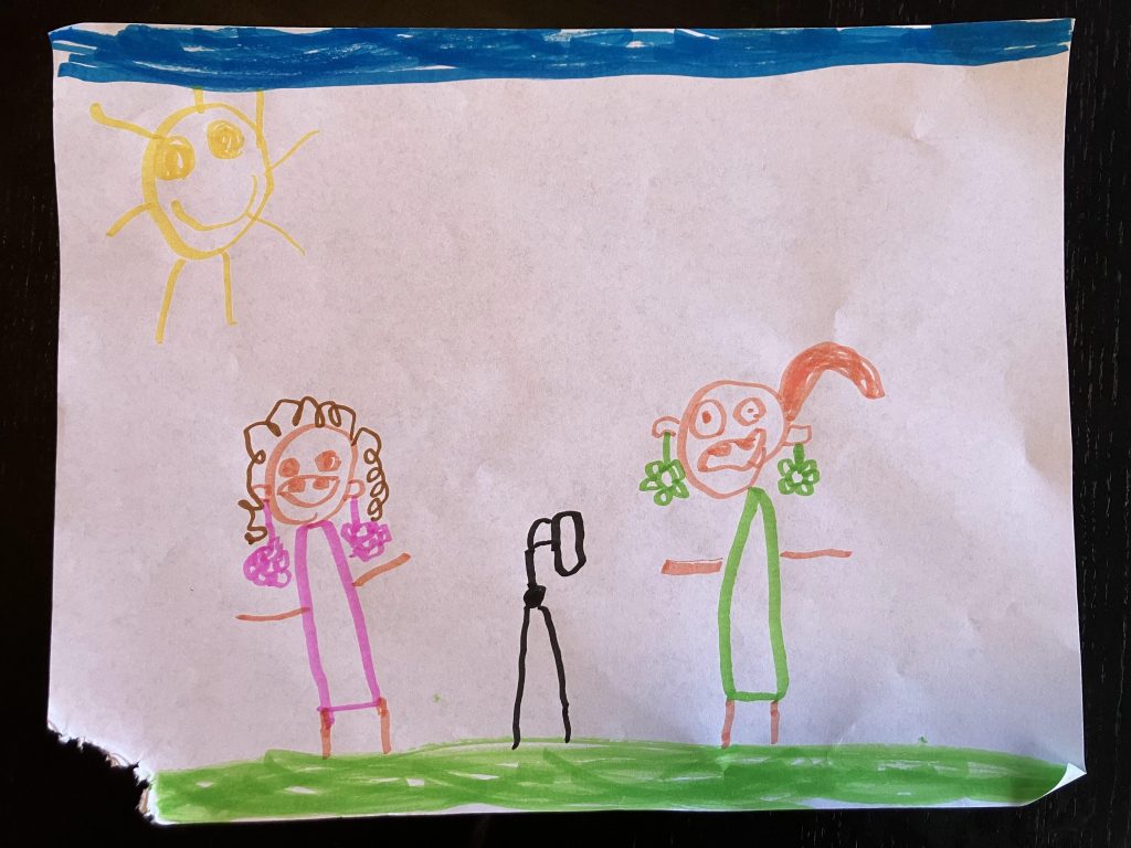 a child's drawing of two women, one with a ponytail and dangly, colorful earrings